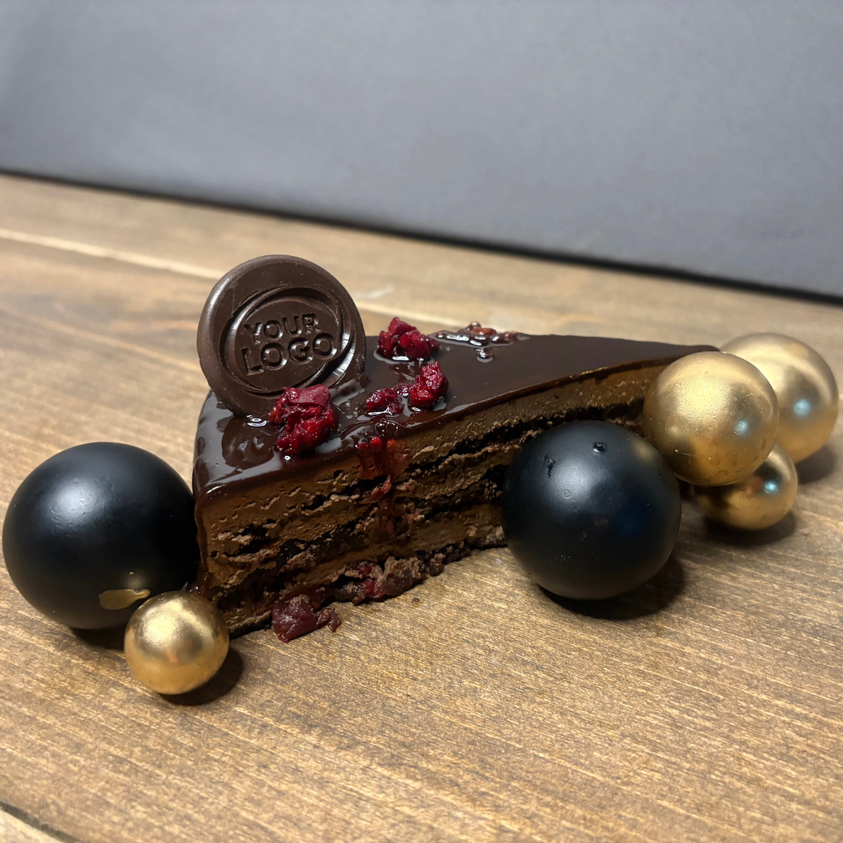 Custom logo chocolate decoration displayed on a chocolate cake