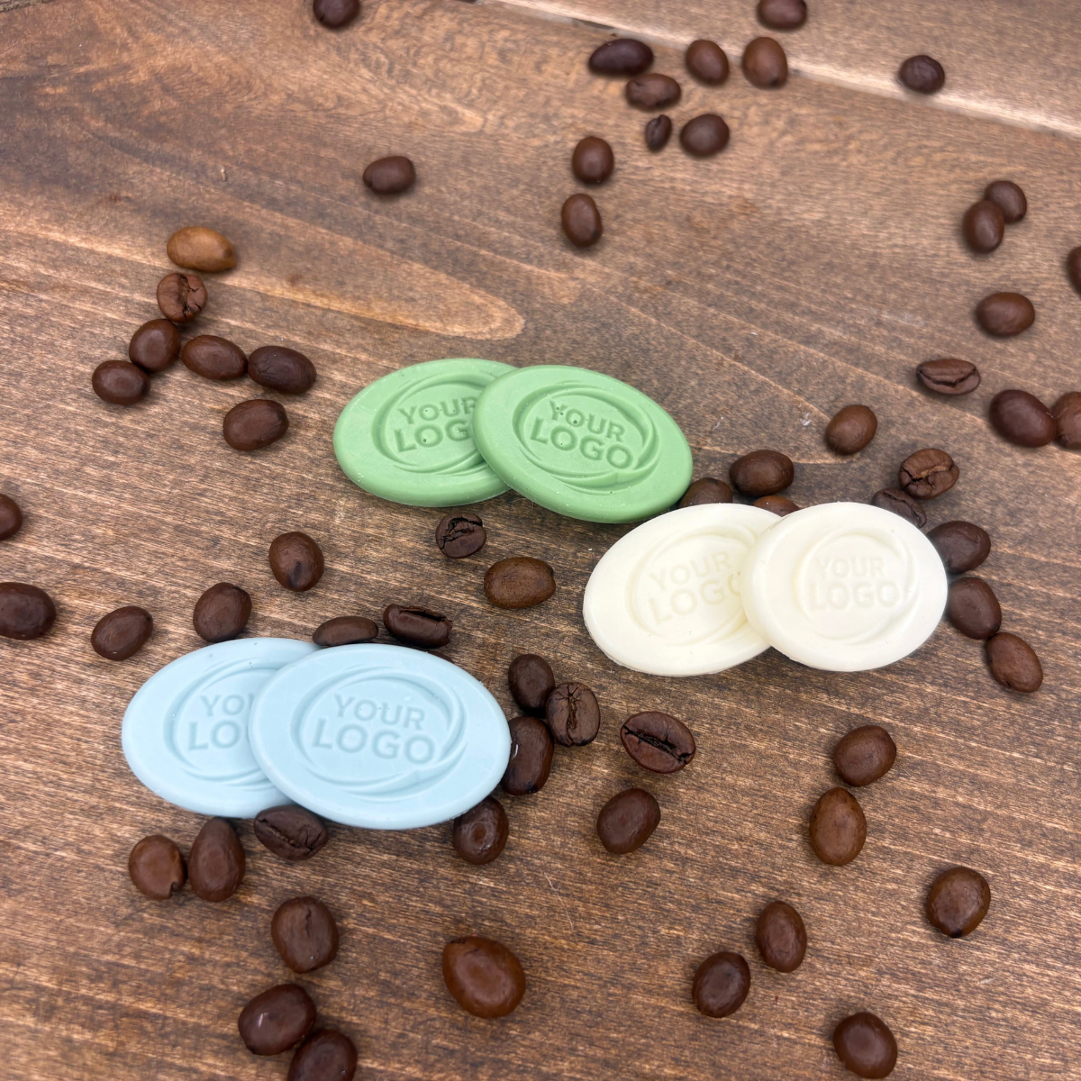 Custom oval logo products arranged with roasted coffee beans