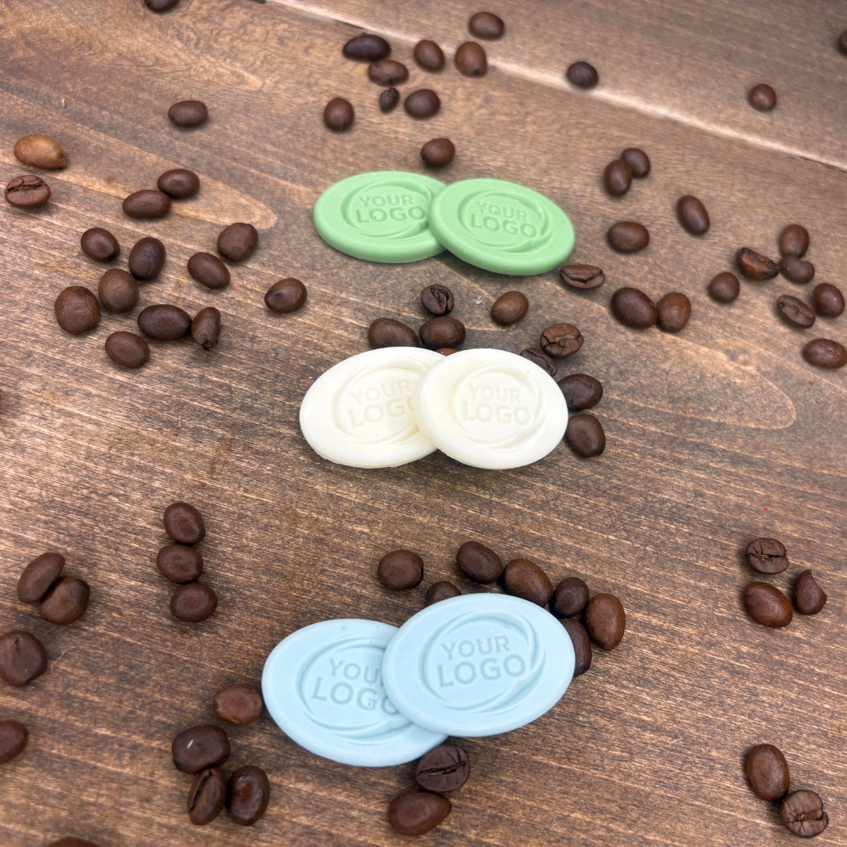 Custom oval logo products in three colors displayed with roasted coffee beans