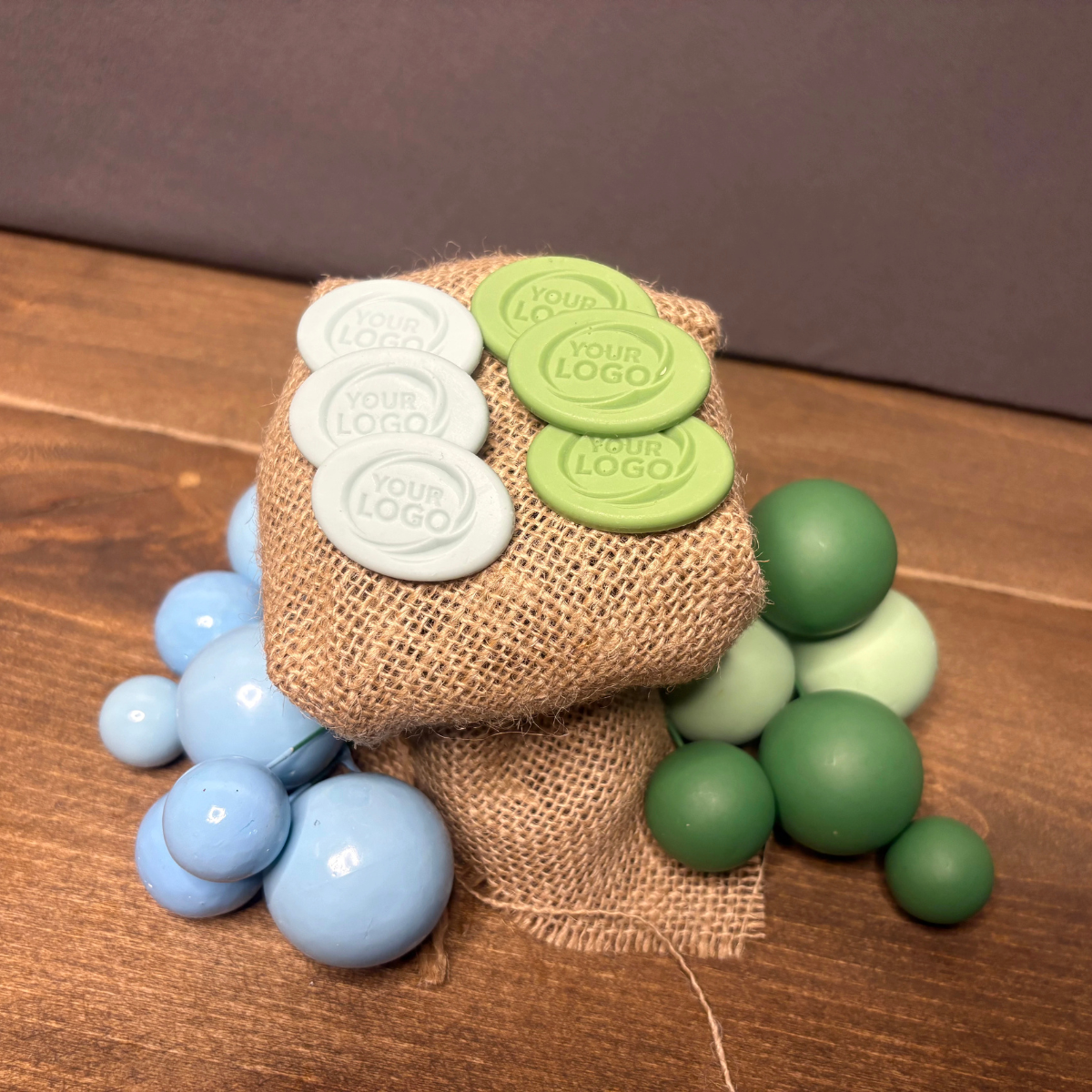 Custom oval silicone products with embossed logo on burlap from another angle