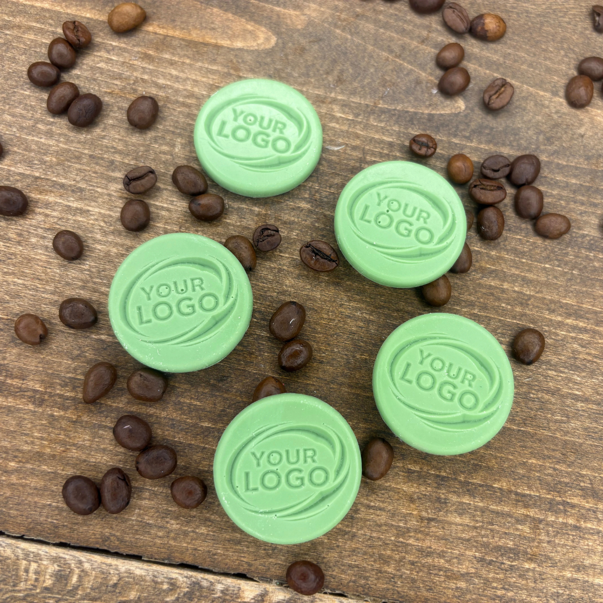 Green round chocolates made with a custom logo mold