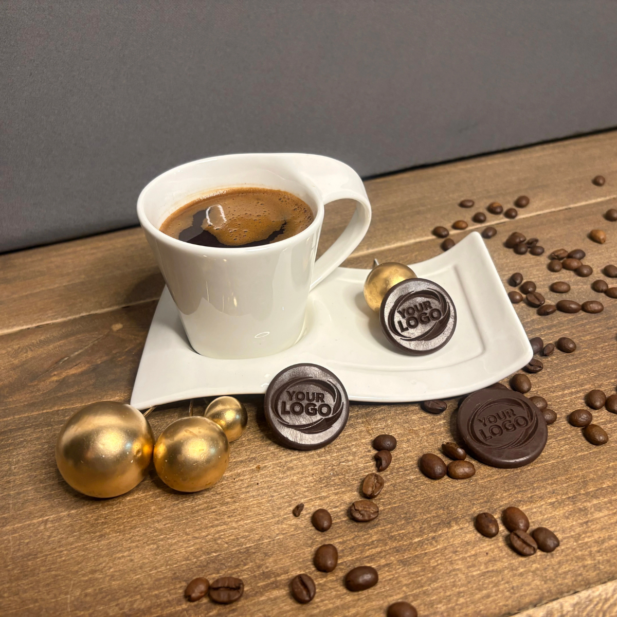 Custom round silicone mold products with embossed logo beside a coffee cup
