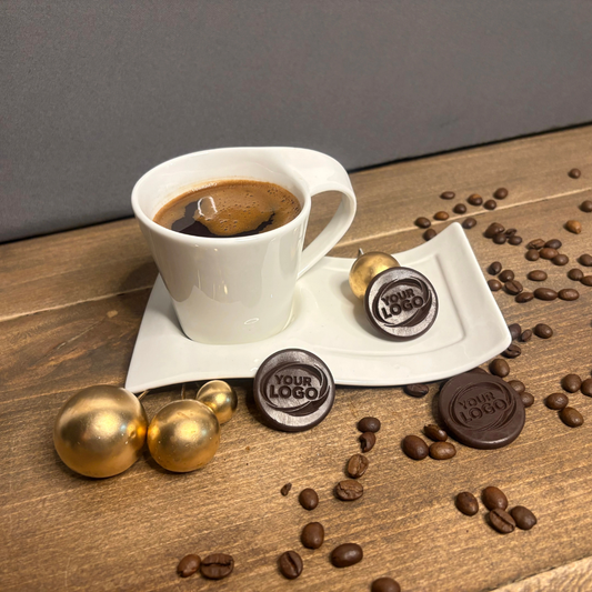 Custom round silicone mold products with embossed logo beside a coffee cup