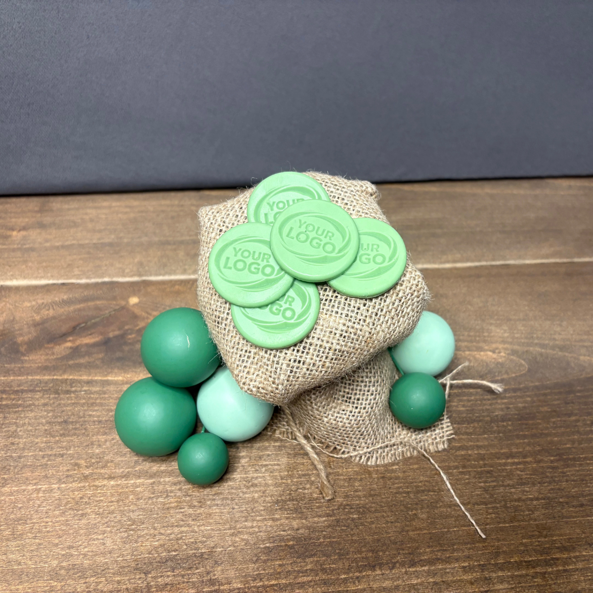 Green round chocolates with a custom embossed logo