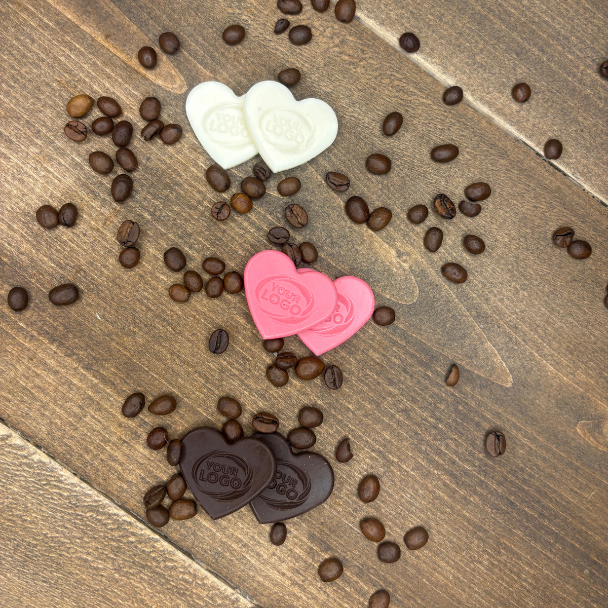 Heart-shaped chocolates with custom logo displayed on coffee beans