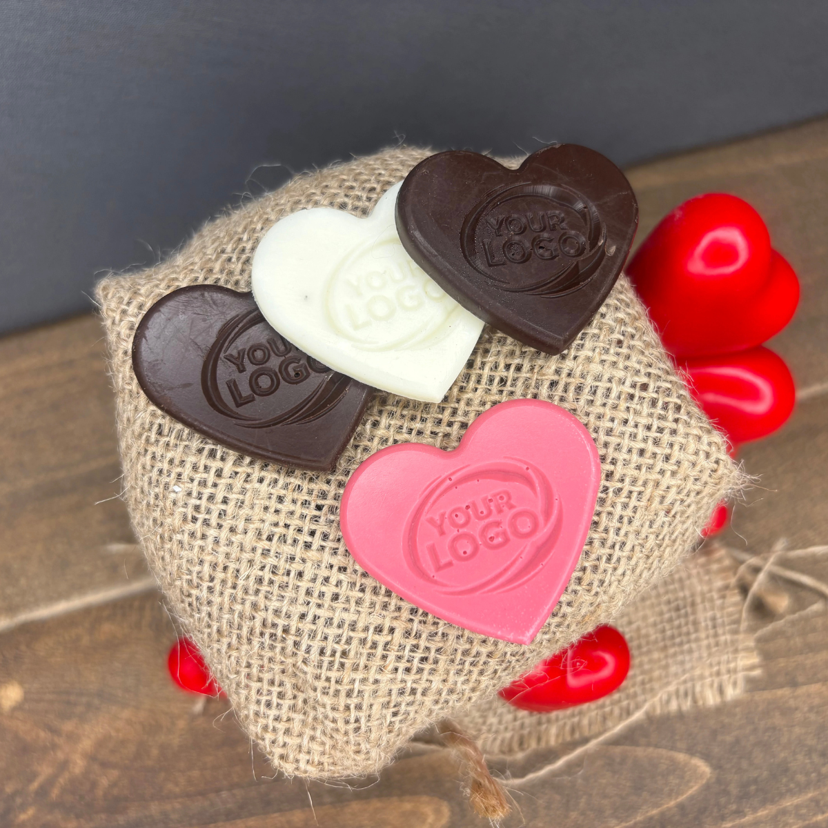 Close-up of personalized heart-shaped chocolates with a custom logo