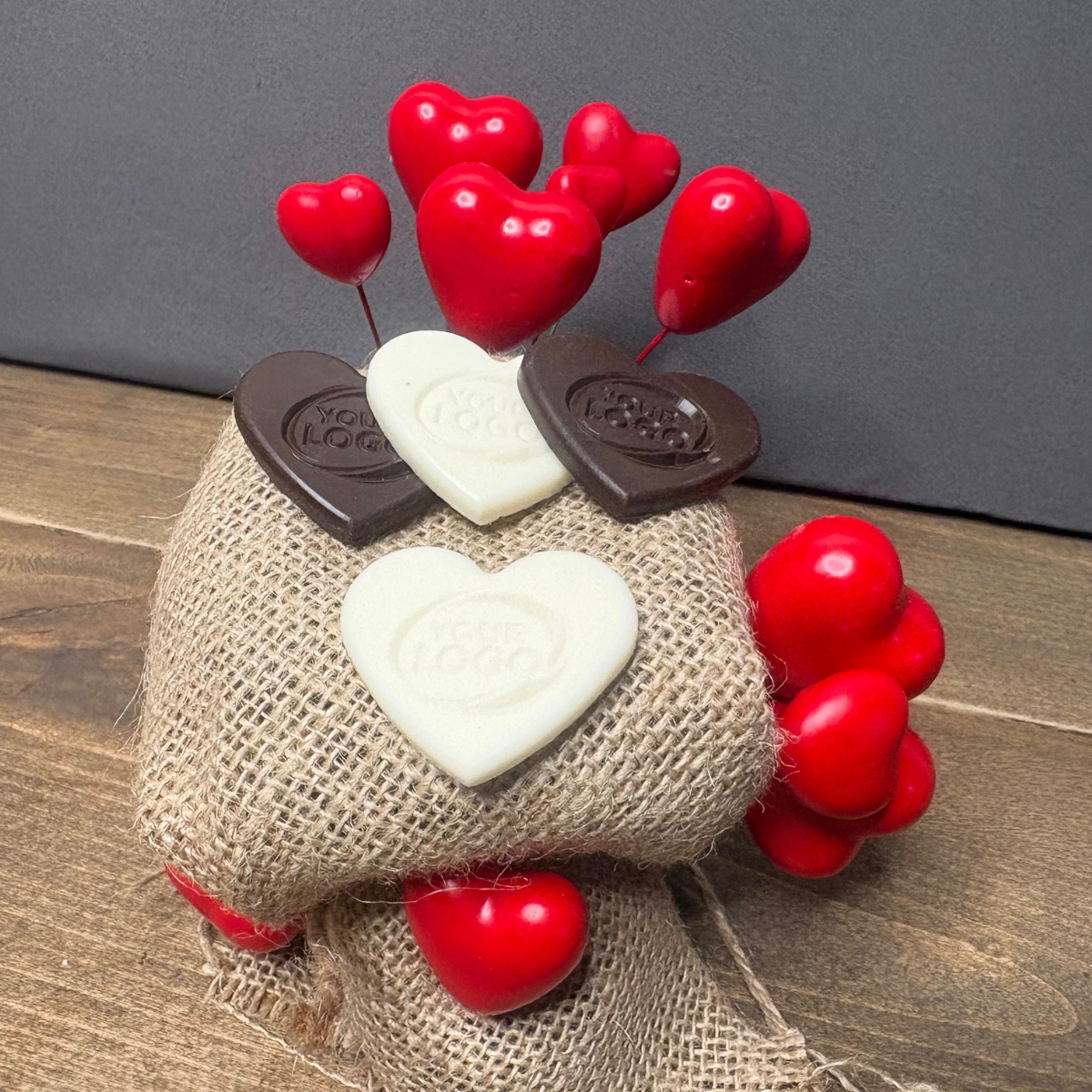 Personalized heart chocolates with custom logo displayed in multiple chocolate colors