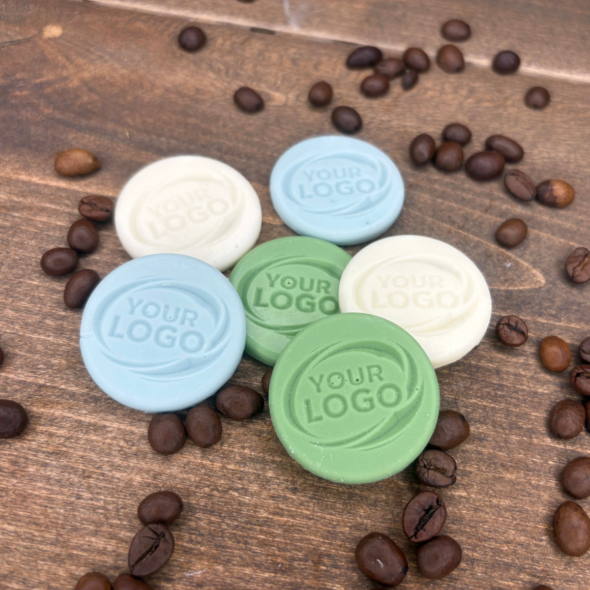 Round branded chocolate samples in green, blue and white